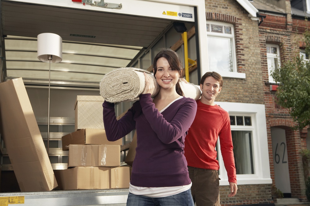 man and woman moving items into a truck