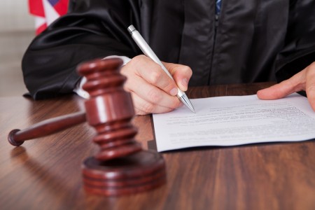 judge signing a paper